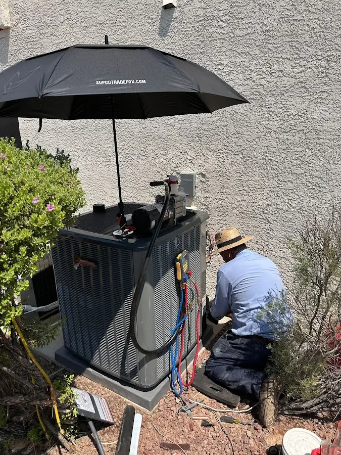 HVAC technician performing outdoor AC maintenance in Minneapolis