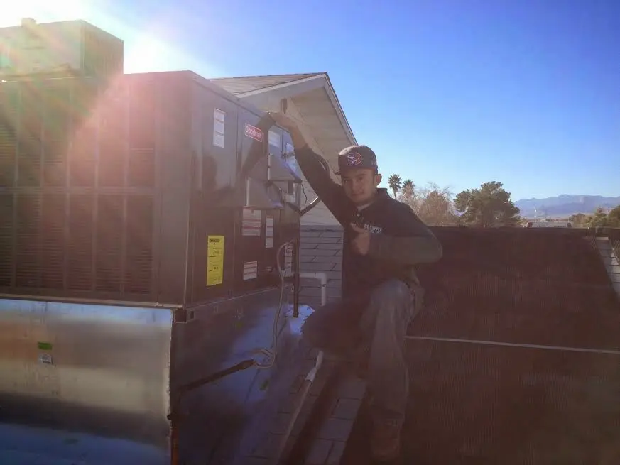 HVAC technician performing HVAC Inspection on a rooftop unit in Minneapolis